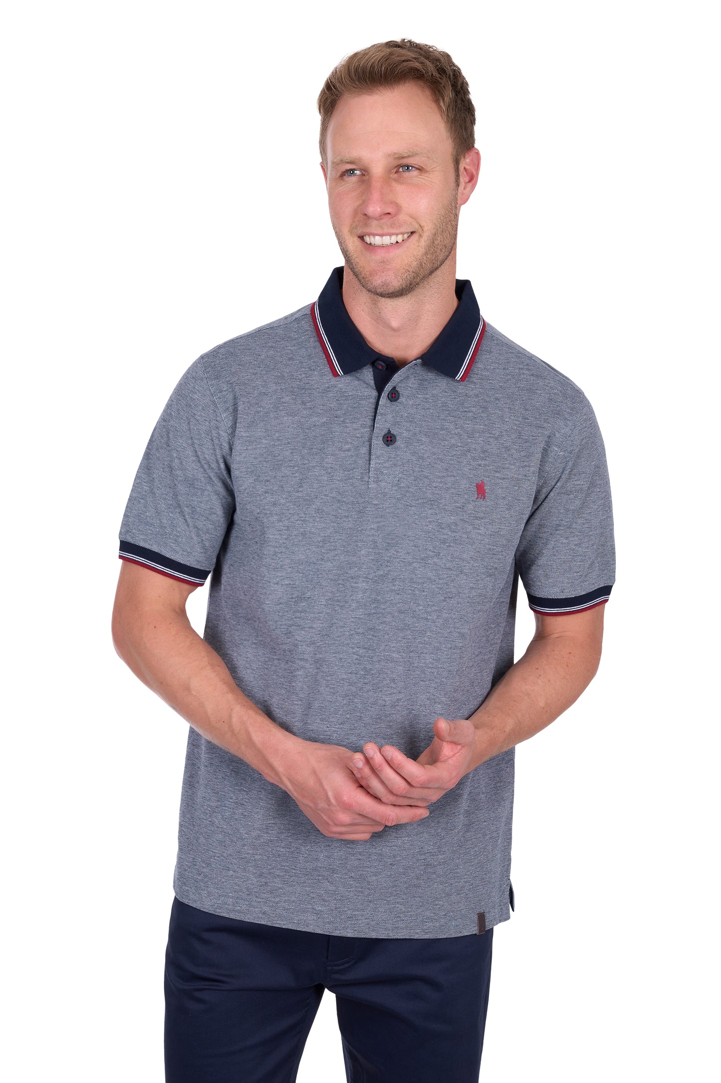 Man wearing a gray polo shirt with navy accents on a white background